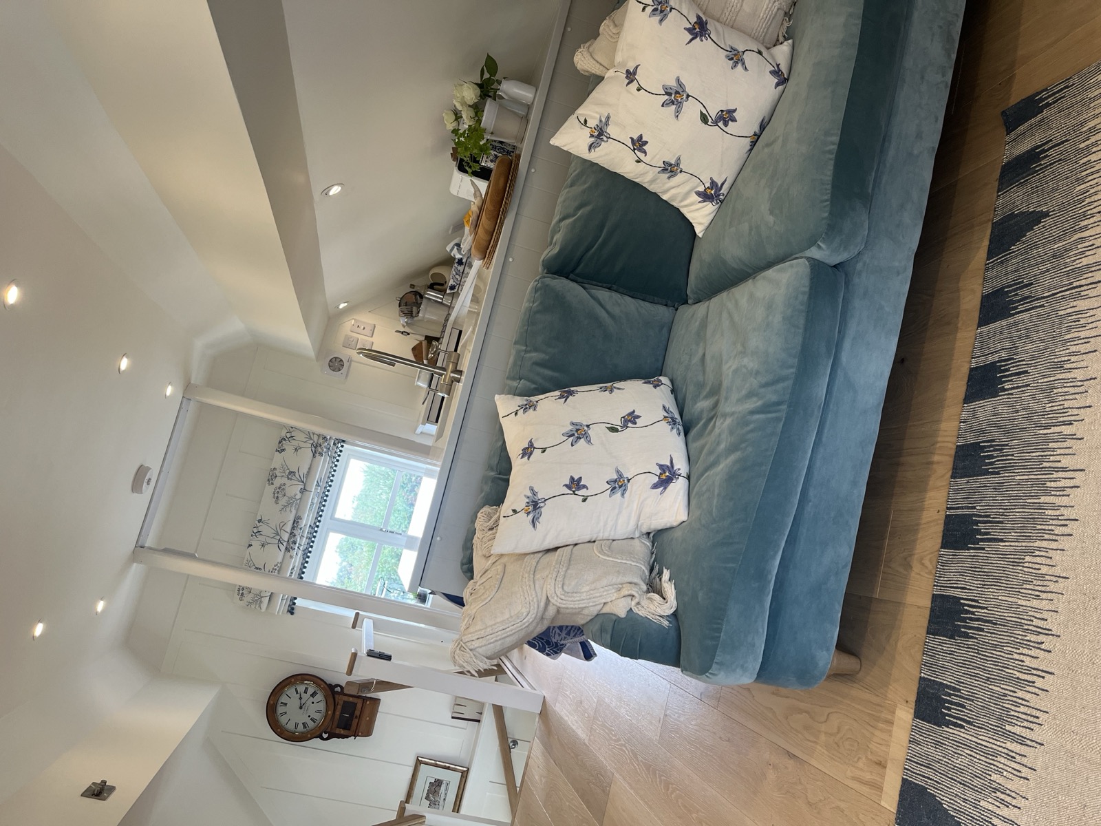 Dolly's House — cosy cottage living room designed for senior living, with duck-egg blue sofa and botanical cushions