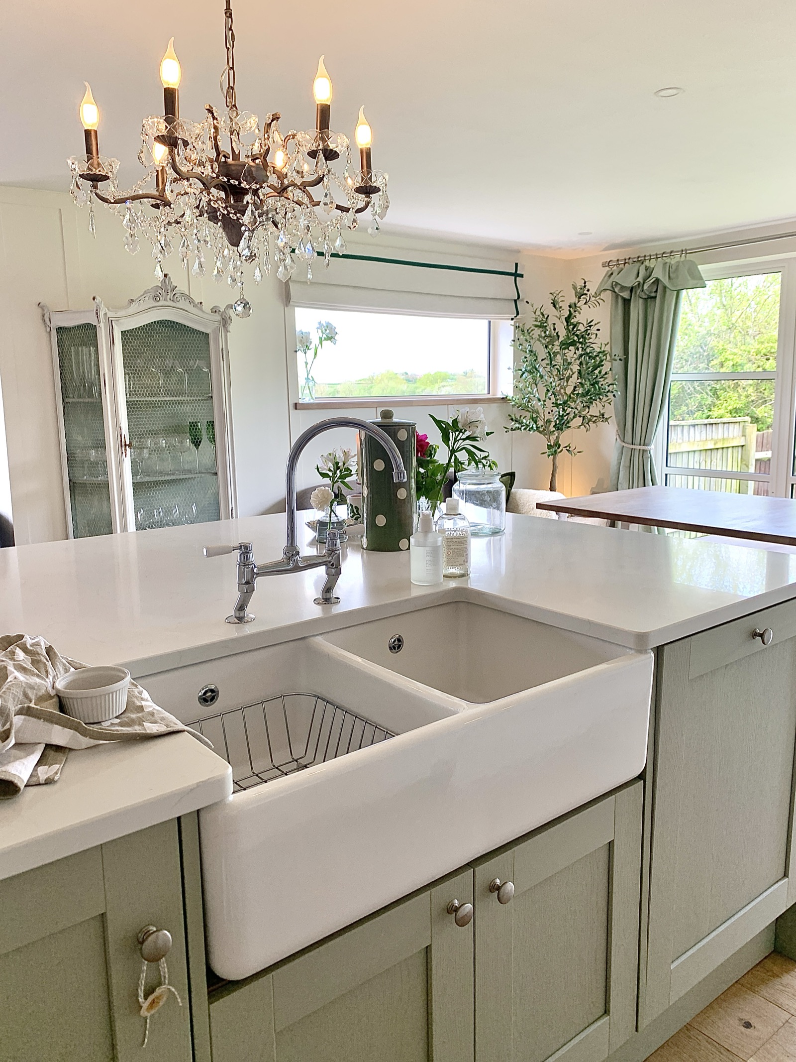 Kitchen island with Belfast sink and crystal chandelier